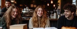 Group of college friends laughing at café table