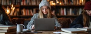 Students sitting together in a cozy library with laptops and study notes.